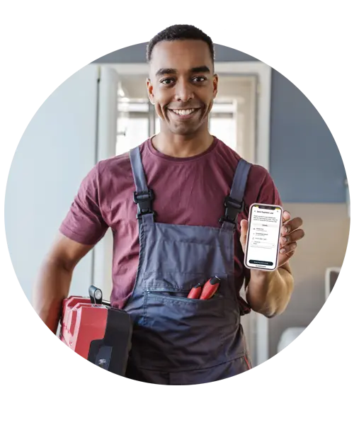 Smiling tradesperson holding smartphone displaying Tidy app interface, showcasing job scheduling and invoicing features for efficient business management.